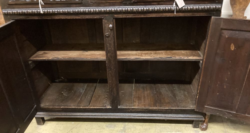 A late 18th century carved oak court cupboard, width 130cm, depth 52cm, height 170cm